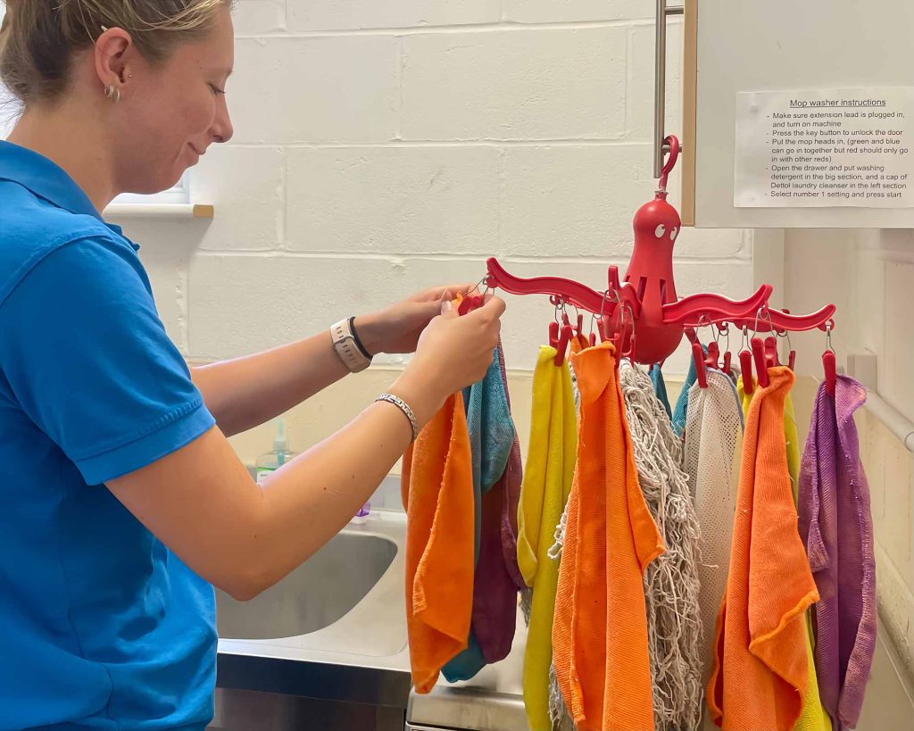 Sunny Days staff hanging cleaning clothes up to dry